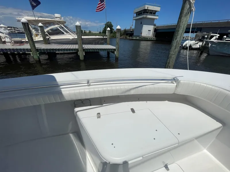 Slide: The Image of 2006 Southport 26 Center Console boat docked near marina with American flag. - 43