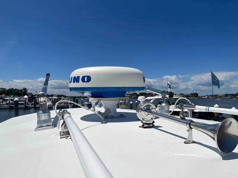Slide: The Image of 2006 Southport 26 Center Console boat with radar and horn, docked under clear blue sky. - 44