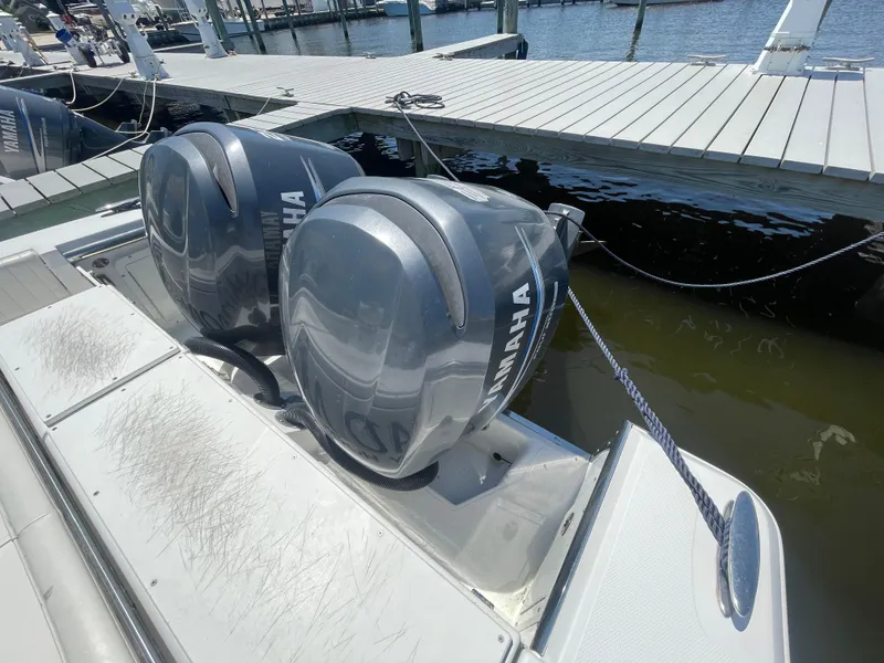 Slide: The Image of Twin Yamaha outboard engines on a 2006 Southport 26 Center Console boat at dock. - 45