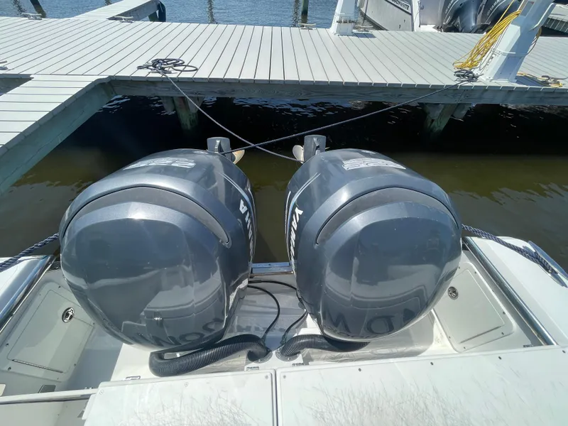 Slide: The Image of Twin Yamaha outboard engines on a 2006 Southport 26 Center Console boat at a dock. - 47