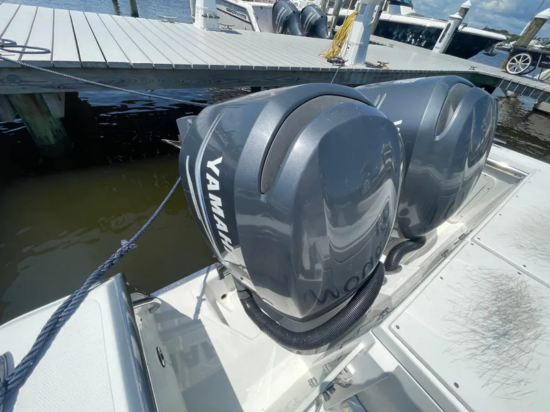 Slide: The Image of Twin Yamaha outboard engines on a 2006 Southport 26 Center Console boat at dock. - 48