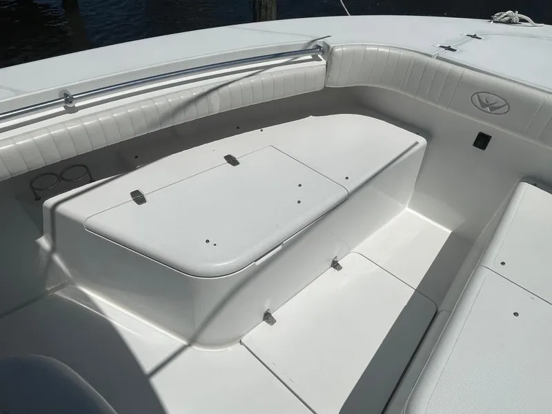 Slide: The Image of 2006 Southport 26 Center Console boat interior with white seating and storage compartments. - 6