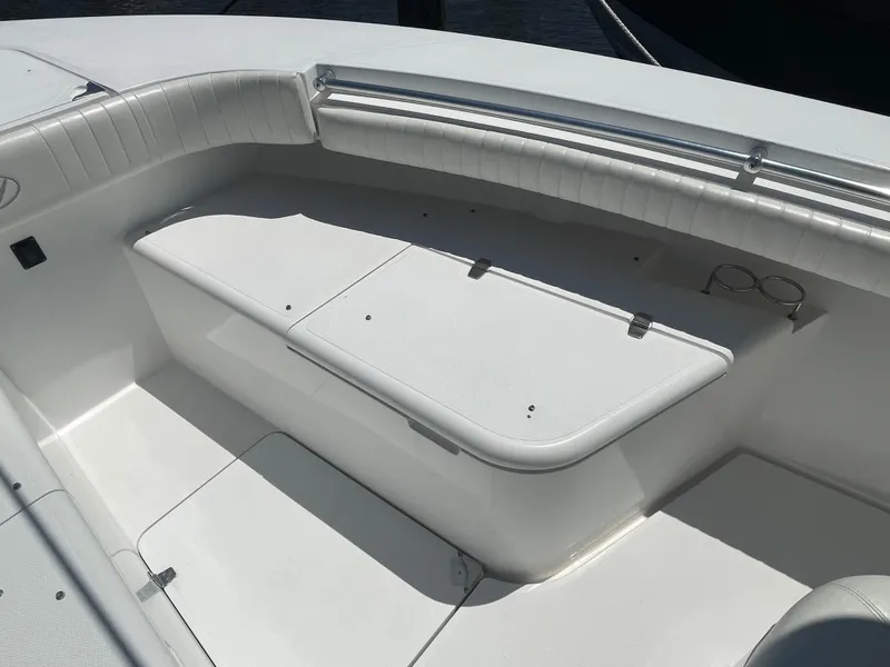 Slide: The Image of 2006 Southport 26 Center Console boat interior with white seating and storage compartments. - 7
