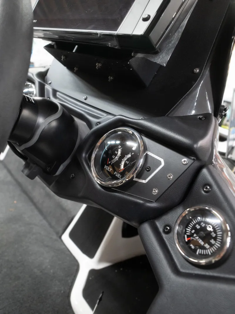 Slide: The Image of 2025 Skeeter ZXR20 dashboard with volt and fuel gauges, sleek black design. - 11