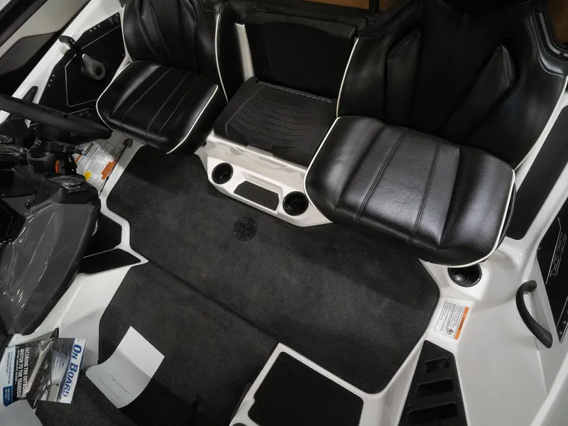 Slide: The Image of 2025 Skeeter ZXR20 boat interior with black leather seats and carpeted flooring. - 6