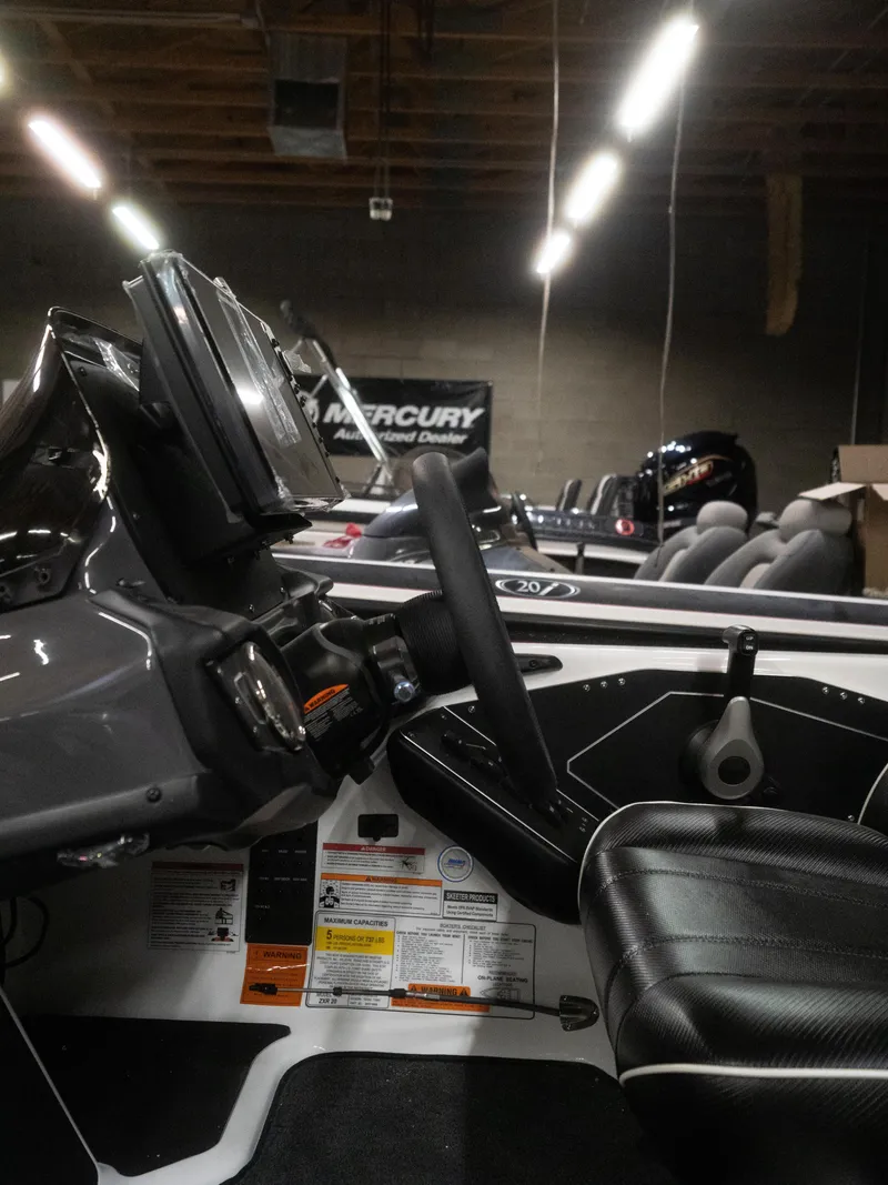 Slide: The Image of Interior of a 2025 Skeeter ZXR20 boat with steering wheel and dashboard controls. - 7