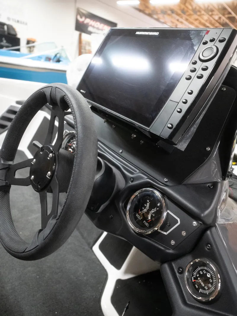 Slide: The Image of Steering wheel and dashboard of 2025 Skeeter ZXR20 boat with navigation display. - 8