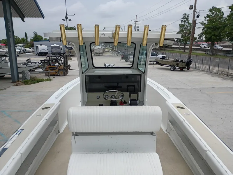 Slide: The Image of 2005 Custom 32CC boat with rod holders, parked in a marina. - 10