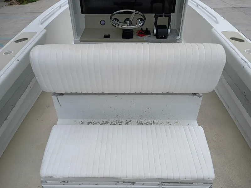 Slide: The Image of White seating on a 2005 Custom 32CC boat with visible wear. - 11