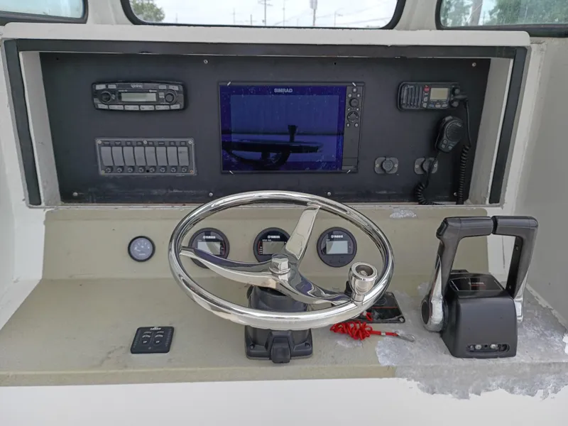 Slide: The Image of Boat control panel with steering wheel, gauges, and navigation equipment, Custom 32CC, 2005 model. - 12