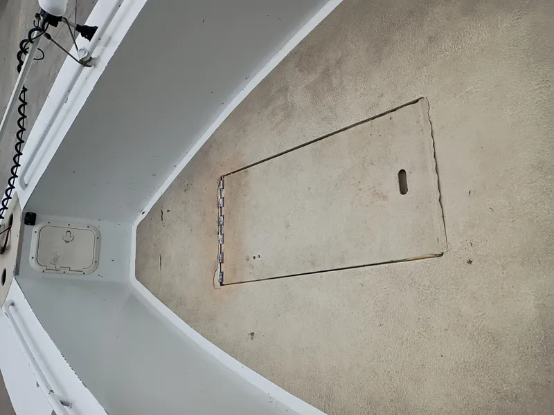 Slide: The Image of Interior of a 2005 Custom 32CC boat showing storage compartment and clean deck. - 16