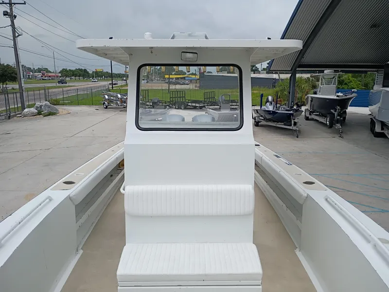 Slide: The Image of Custom 32CC 2005 boat with cabin, parked in a marina, overcast sky. - 17