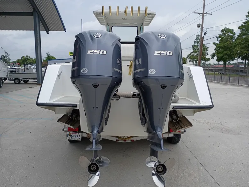 Slide: The Image of Twin Yamaha 250 outboard motors on a 2005 Custom 32CC boat at a marina. - 3