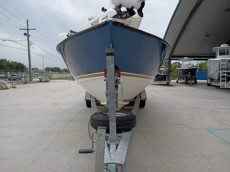 Slide: The Image of Blue and white Custom 32CC boat on trailer, parked outdoors, 2005 model. - 6