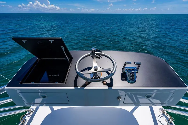 Slide: The Image of 2023 Hatteras GT45X helm with Garmin navigation, overlooking the ocean. - 11