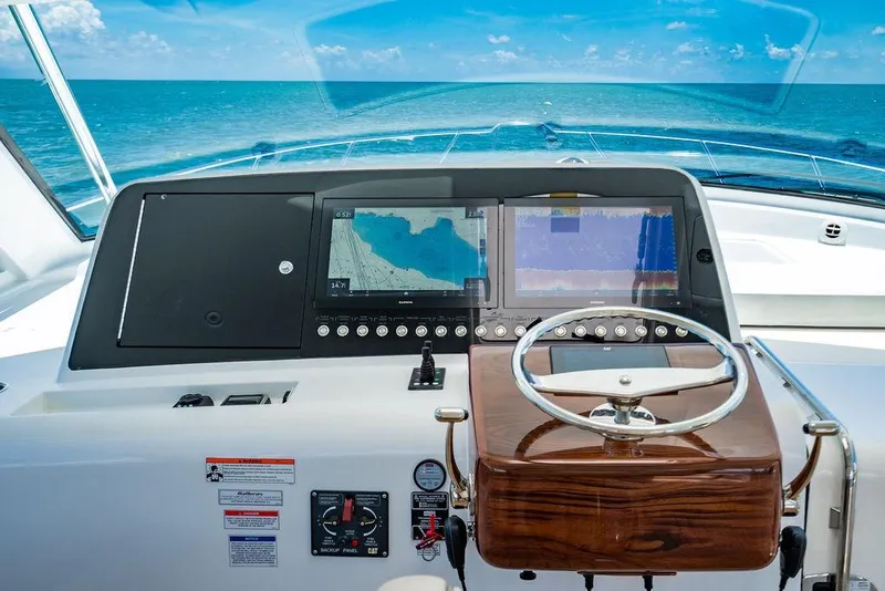 Slide: The Image of 2023 Hatteras GT45X yacht helm with navigation screens and ocean view. - 14
