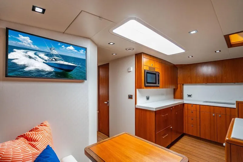 Slide: The Image of Luxurious interior of 2023 Hatteras GT45X yacht with modern kitchen and wall art. - 20