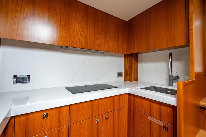 Slide: The Image of Luxurious kitchen interior of 2023 Hatteras GT45X yacht with sleek wood cabinetry. - 21