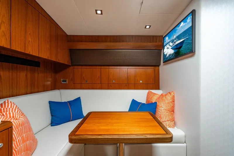 Slide: The Image of Luxurious 2023 Hatteras GT45X yacht interior with wooden cabinetry and cozy seating area. - 22