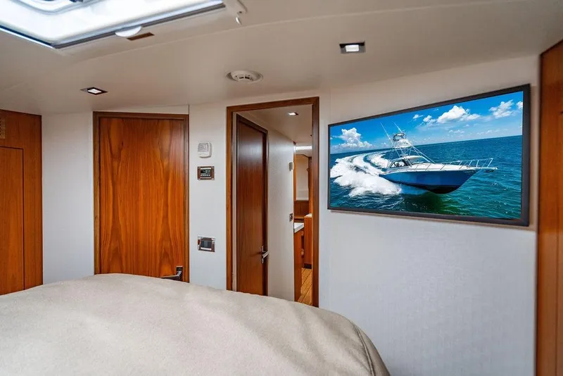Slide: The Image of Luxurious 2023 Hatteras GT45X yacht interior with wood accents and ocean view artwork. - 25