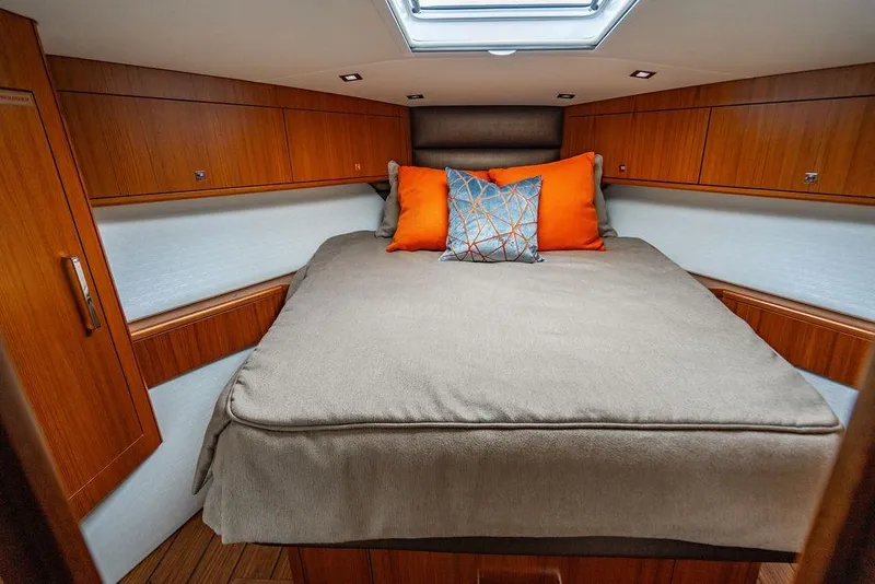 Slide: The Image of Luxurious cabin interior of 2023 Hatteras GT45X yacht with cozy bedding and vibrant pillows. - 26