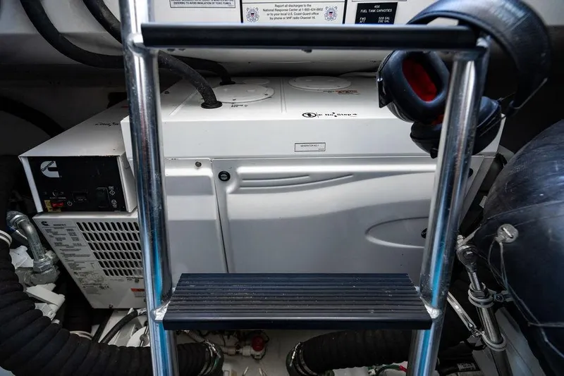 Slide: The Image of Engine room of 2023 Hatteras GT45X yacht, featuring Cummins generator and equipment. - 31