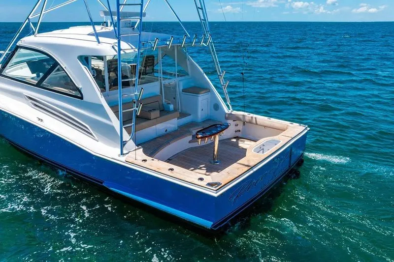 Slide: The Image of 2023 Hatteras GT45X yacht on open sea, featuring sleek design and spacious deck. - 5