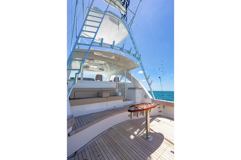 Slide: The Image of 2023 Hatteras GT45X yacht deck with seating and ocean view. - 8