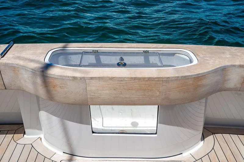 Slide: The Image of 2023 Hatteras GT45X yacht deck with elegant wood finish and ocean view. - 9