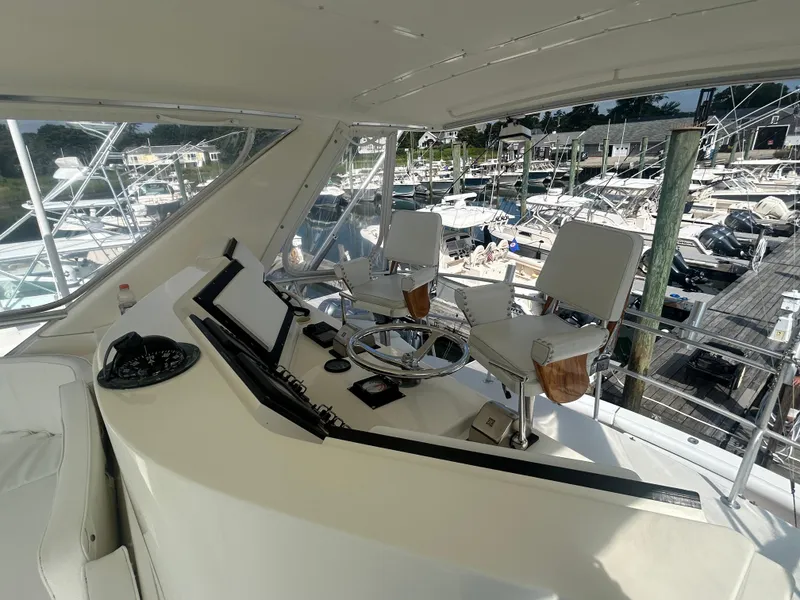 Slide: The Image of Cockpit of a 1990 Bertram 50 Convertible yacht with marina view. - 11