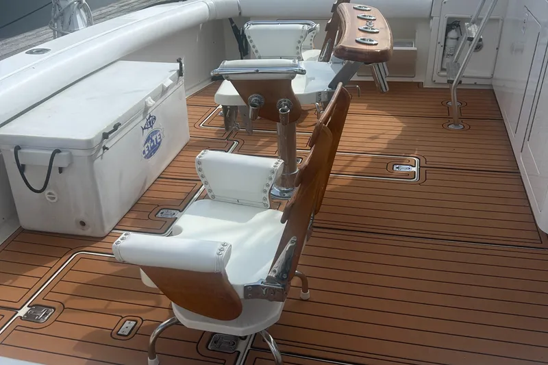 Slide: The Image of Bertram 50 Convertible 1990 boat deck with fishing chairs and cooler. - 16