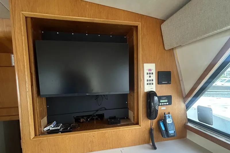 Slide: The Image of Interior of a 1990 Bertram 50 Convertible yacht with TV and communication devices. - 27