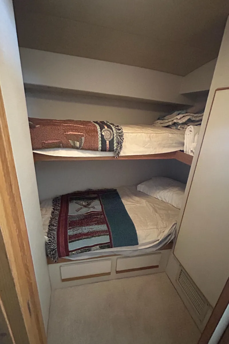 Slide: The Image of Cozy bunk beds in a 1990 Bertram 50 Convertible yacht cabin. - 30