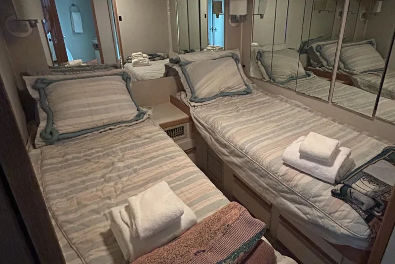 Slide: The Image of Twin beds in a cozy cabin of a 1990 Bertram 50 Convertible yacht. - 32