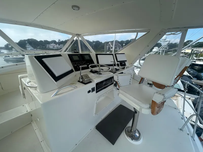 Slide: The Image of Cockpit of a 1990 Bertram 50 Convertible yacht with modern navigation equipment. - 7