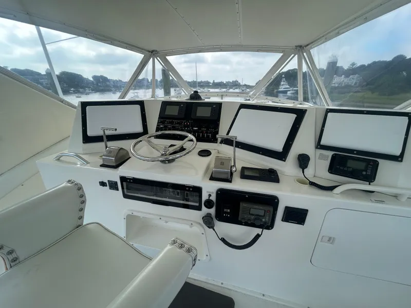 Slide: The Image of Cockpit of 1990 Bertram 50 Convertible yacht with steering wheel and navigation equipment. - 8