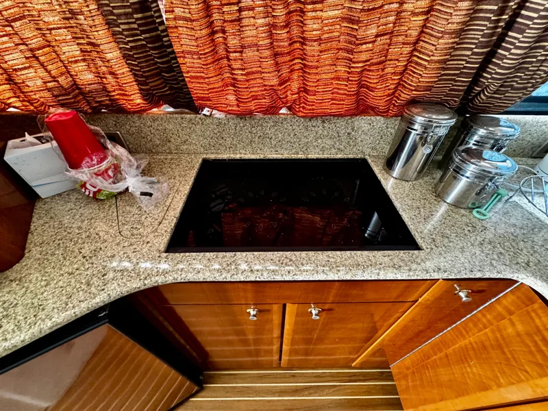Slide: The Image of Kitchen area of a 2007 Meridian 411 Sedan with granite countertop and stove. - 13