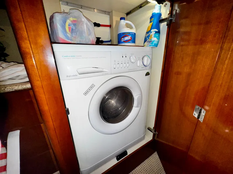 Slide: The Image of Laundry area inside a 2007 Meridian 411 Sedan yacht with a washing machine. - 17
