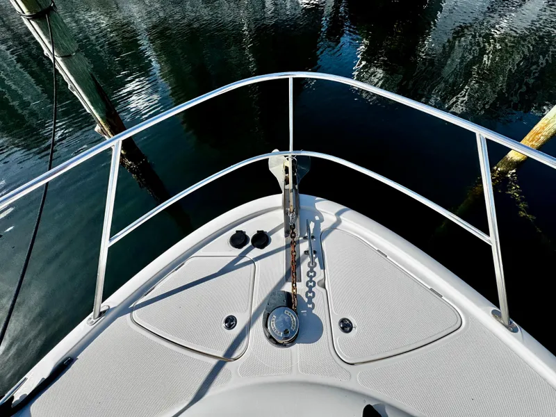 Slide: The Image of Bow of 2007 Meridian 411 Sedan yacht with anchor chain, docked on calm water. - 3