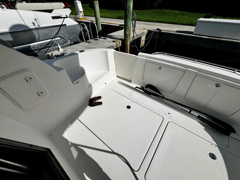 Slide: The Image of 2007 Meridian 411 Sedan boat deck with storage compartments and docked alongside another vessel. - 4