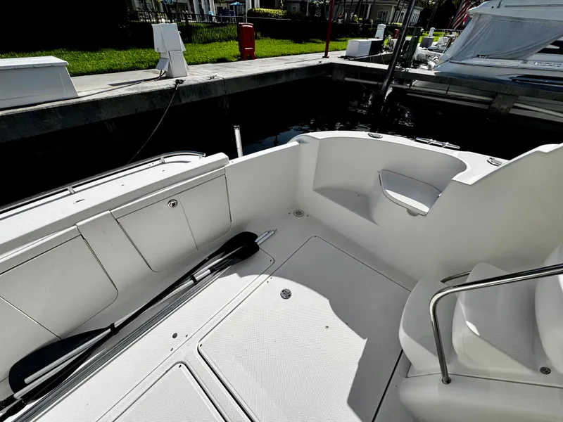 Slide: The Image of 2007 Meridian 411 Sedan boat deck with seating and storage at a marina. - 5
