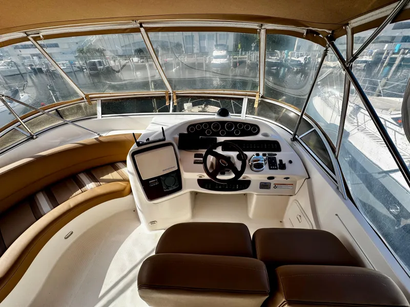 Slide: The Image of 2007 Meridian 411 Sedan helm with panoramic marina view, featuring modern controls and seating. - 6
