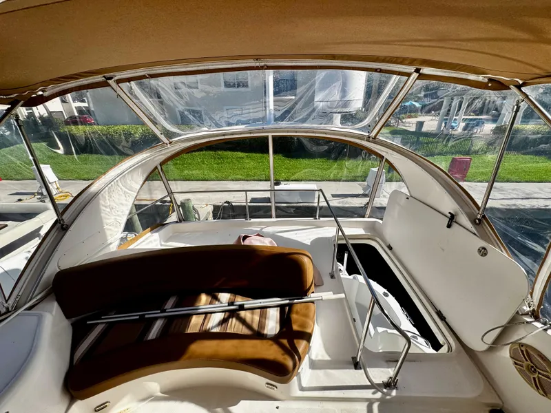Slide: The Image of 2007 Meridian 411 Sedan yacht interior with brown seating and open hatch. - 7