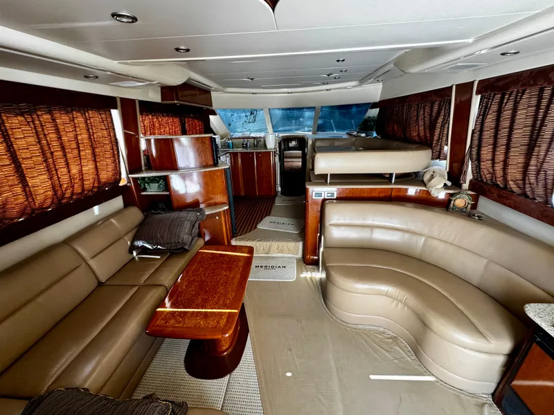 Slide: The Image of Luxurious interior of a 2007 Meridian 411 Sedan yacht with leather seating and wooden accents. - 8