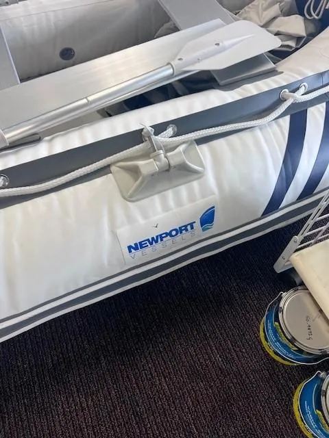 Slide: The Image of Newport 4D inflatable boat, 2020 model, with oars and logo visible. - 4