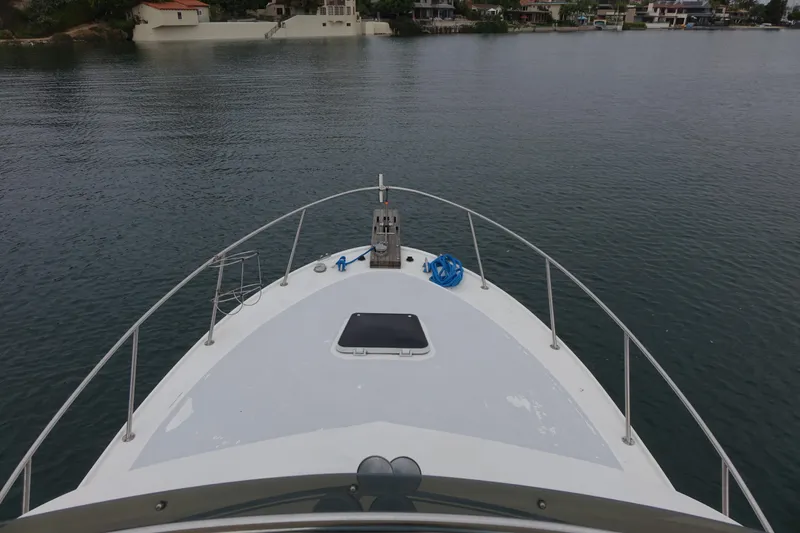 Slide: The Image of 1988 Blackfin 29 Flybridge boat on calm water, view from bow. - 13