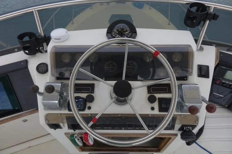 Slide: The Image of 1988 Blackfin 29 Flybridge helm with steering wheel and navigation instruments. - 15