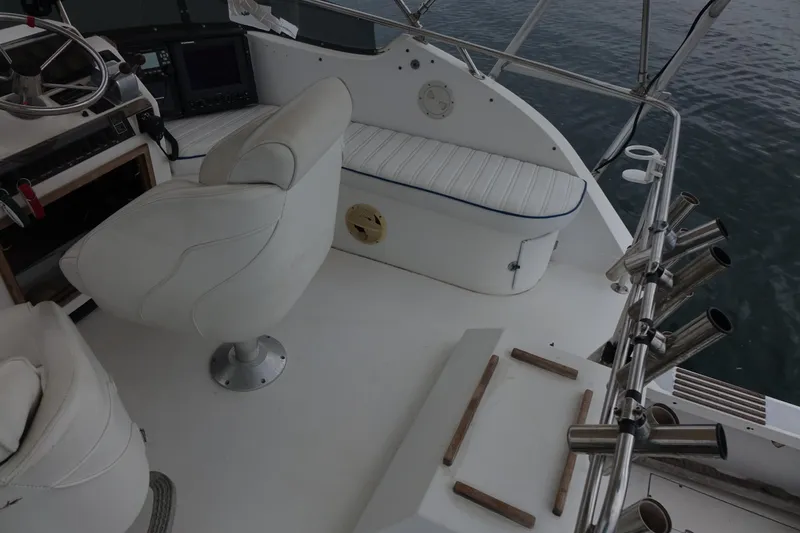 Slide: The Image of 1988 Blackfin 29 Flybridge interior with white seating and control panel. - 18
