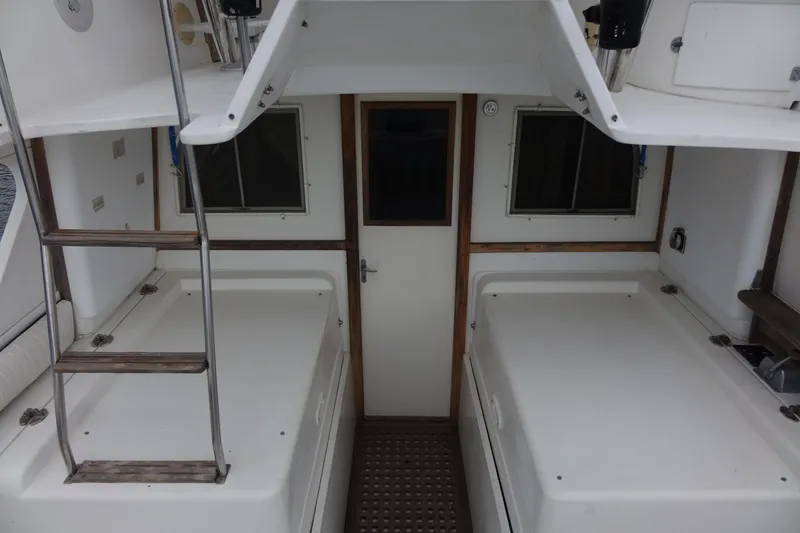 Slide: The Image of 1988 Blackfin 29 Flybridge interior with ladder, windows, and door. - 24