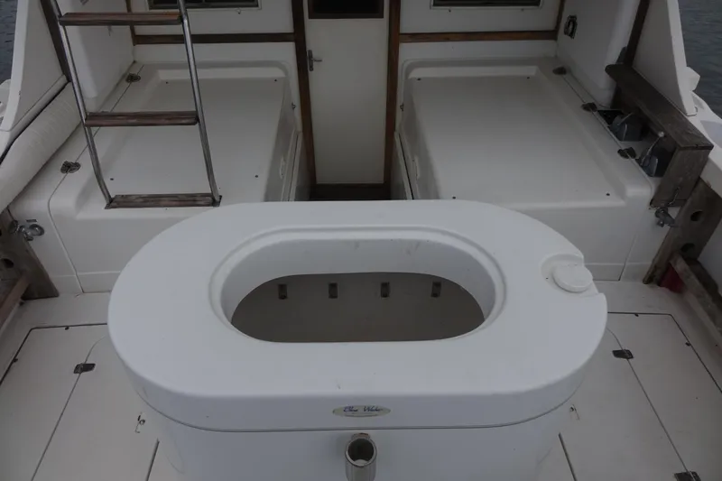 Slide: The Image of 1988 Blackfin 29 Flybridge boat interior with ladder and storage compartments. - 25